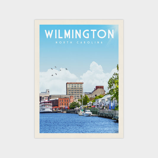 A poster of Wilmington, North Carolina, featuring a cityscape with boats on the water and a clear blue sky with clouds.