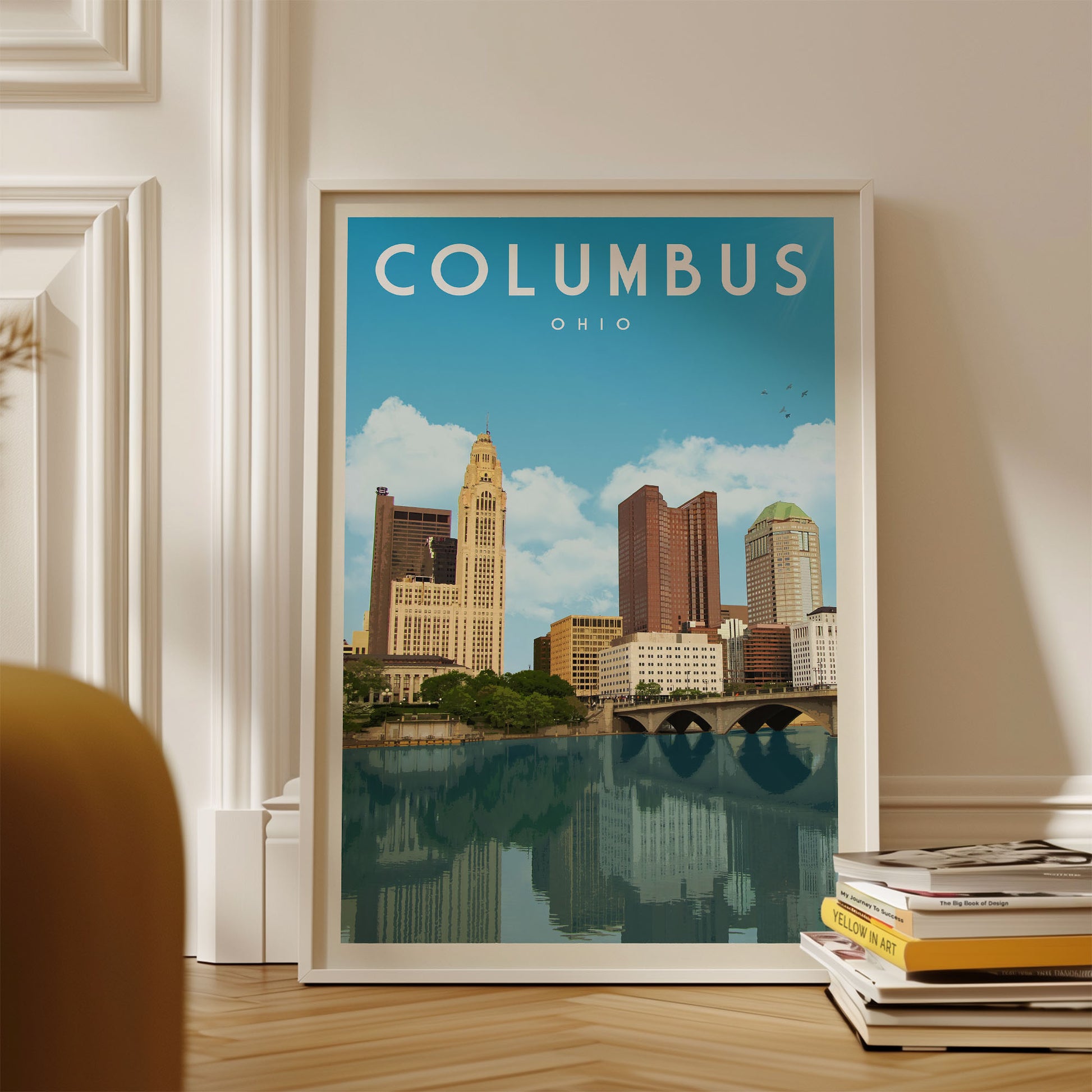 A framed poster of the skyline of Columbus, Ohio, with a river and buildings visible in the background.