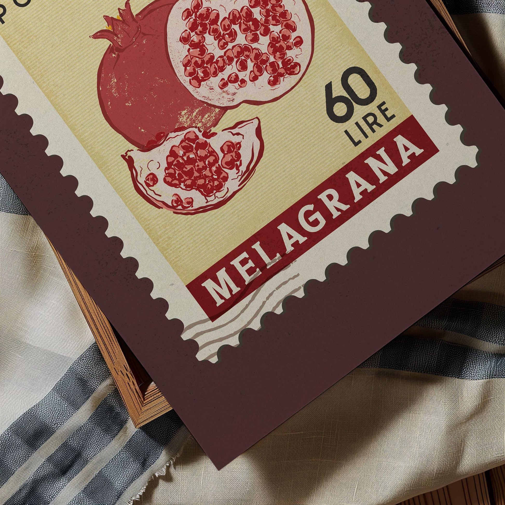 A close-up of a postage stamp featuring an illustration of pomegranates, with the text &quot;60 LIRNE&quot; printed on it.