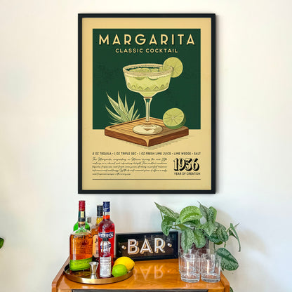 a framed poster of a Margarita cocktail hanging on a wall above a wooden bar counter with various liquor bottles and glasses.