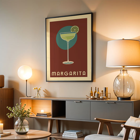 a living room with a framed poster of a margarita glass on the wall, a lamp, a coffee table, and a bookshelf.