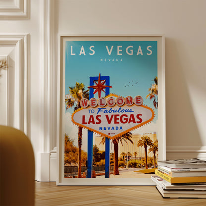A framed poster of the iconic "Welcome to Fabulous Las Vegas, Nevada" sign, with a clear view of the sign and the surrounding palm trees and buildings.