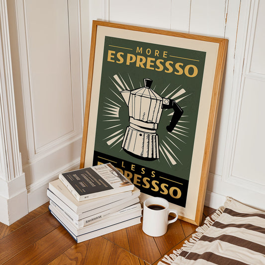 a framed poster with the text "MORE ESPRESSO" and an illustration of a coffee maker, accompanied by a stack of books and a cup of coffee on a wooden floor.