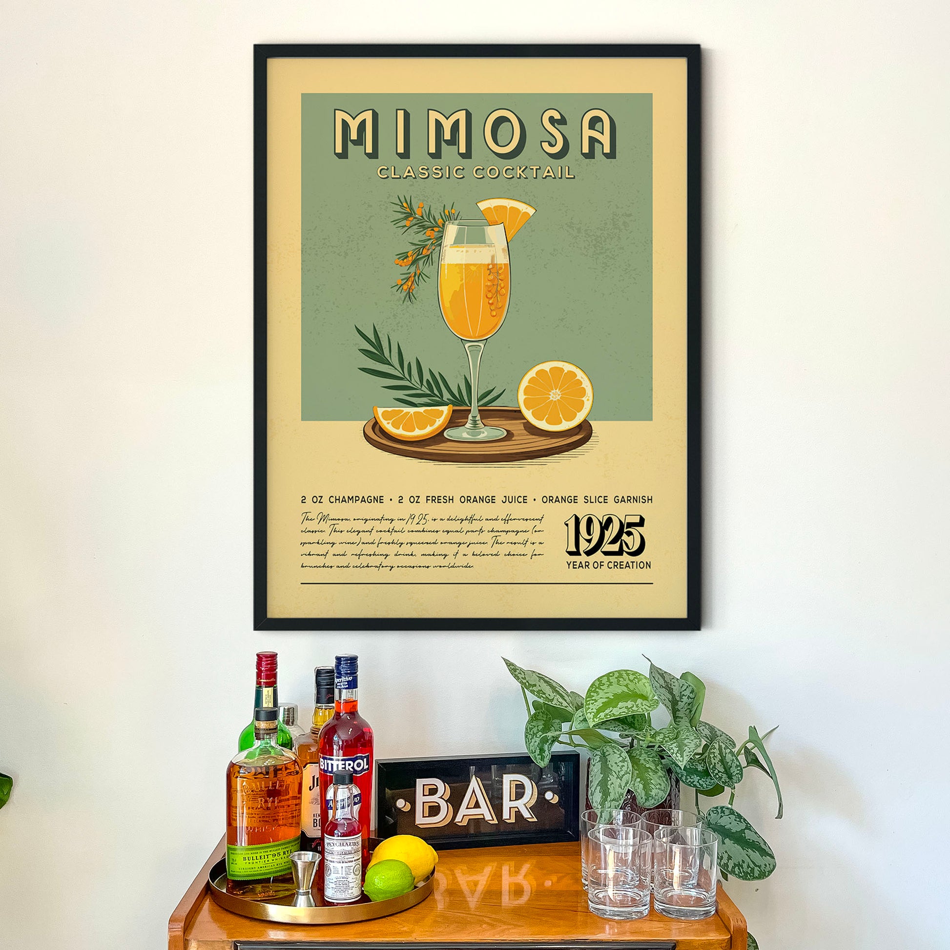 a framed poster of a mimosa cocktail hanging on a wall above a wooden bar counter with various liquor bottles and glasses.