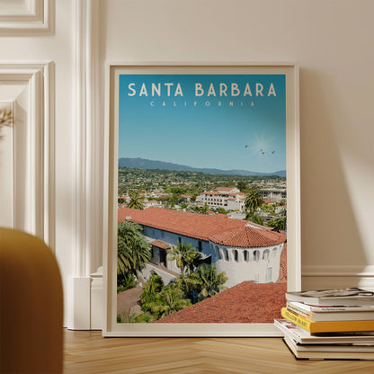 A framed poster of Santa Barbara, California, with a view of the city and mountains in the background.