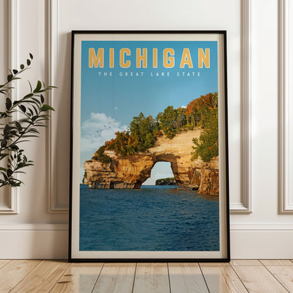 A framed poster of the Great Lakes State of Michigan, featuring a scenic view of the lake surrounded by rocky cliffs and autumn foliage.