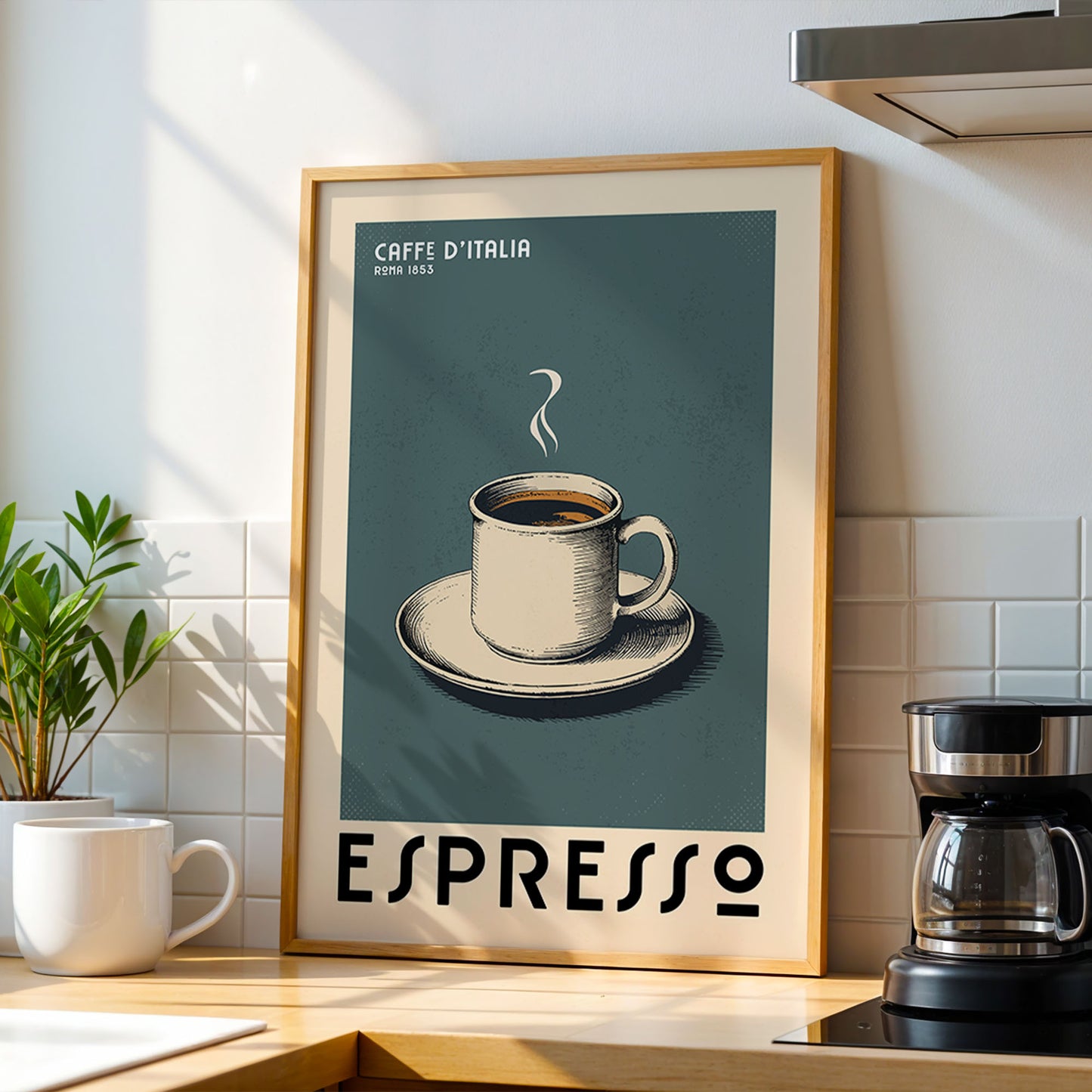 a framed poster of a cup of espresso on a table, with a coffee maker and a potted plant in the background.