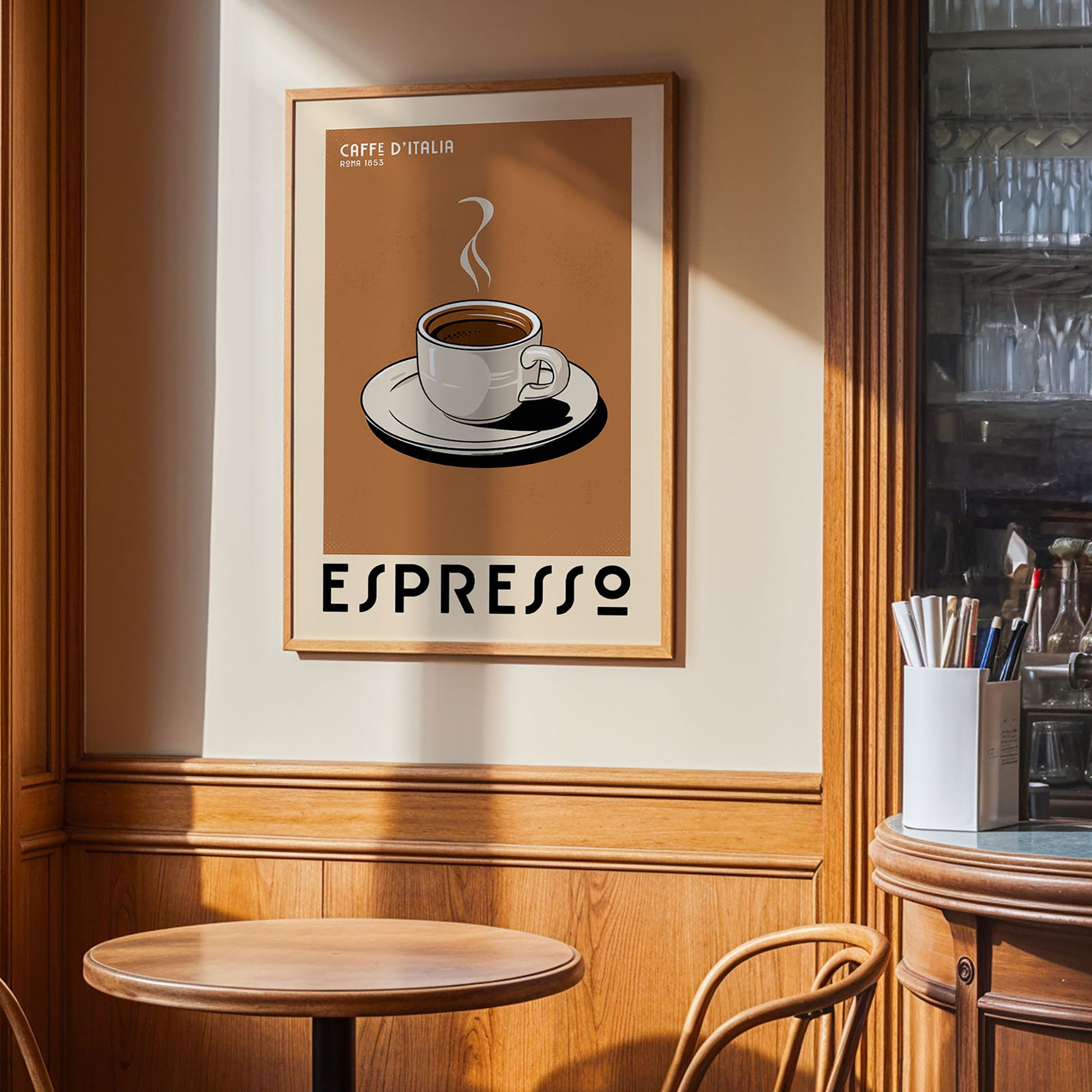 a framed poster of a cup of espresso on a wall, with a wooden table and chairs in the foreground.