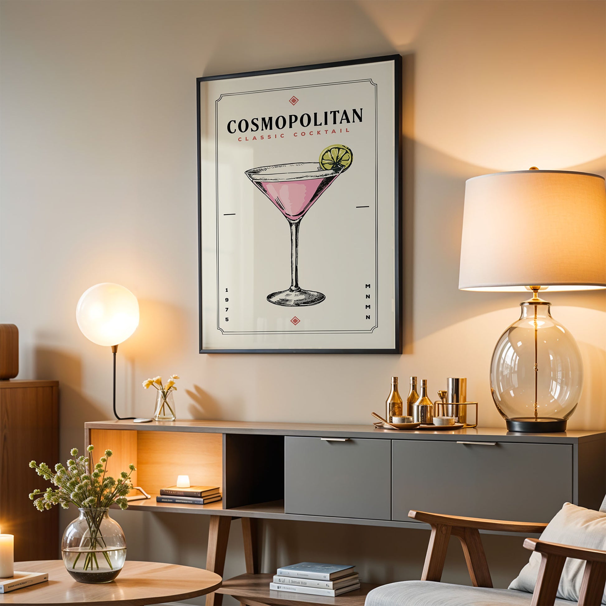 a living room with a framed poster of a cocktail on the wall, a lamp, a coffee table, and a bookshelf.