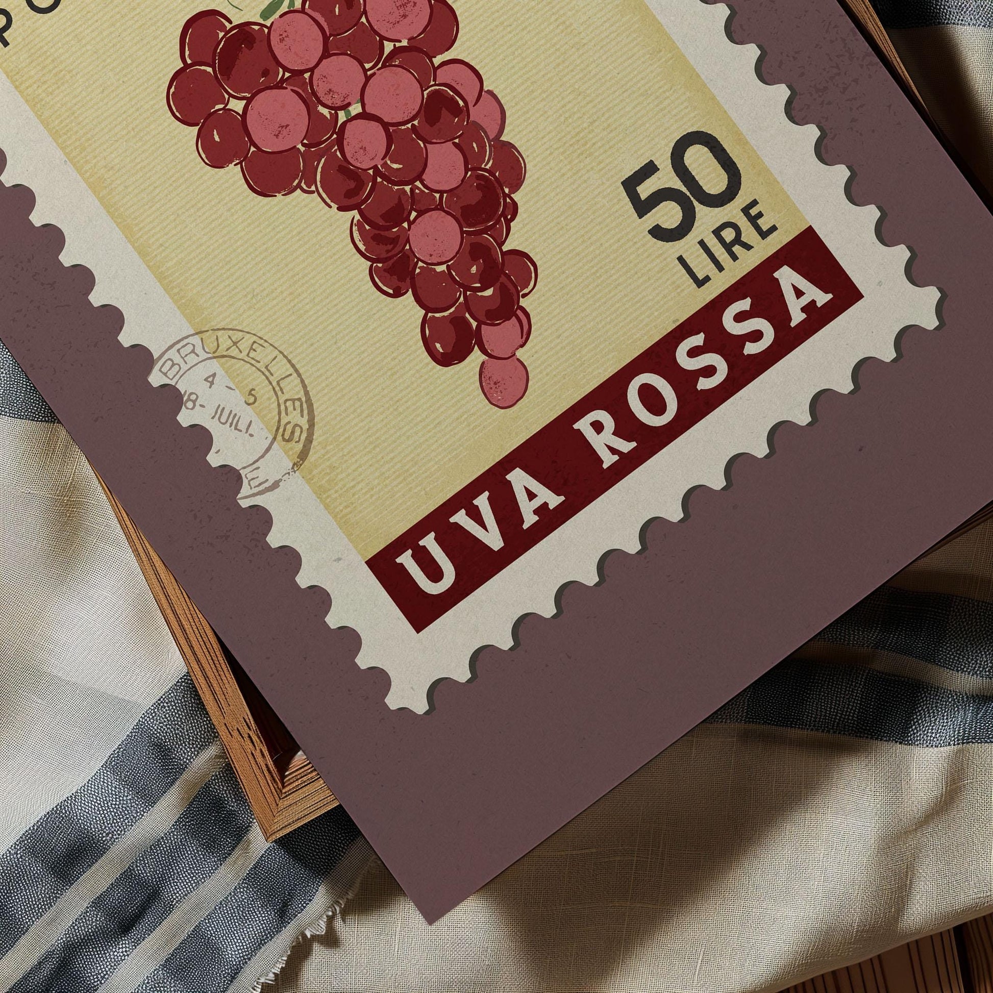 a close-up of a postage stamp with a depiction of a bunch of red grapes. The stamp has a value of 50 lire and is printed in the country of Italy.