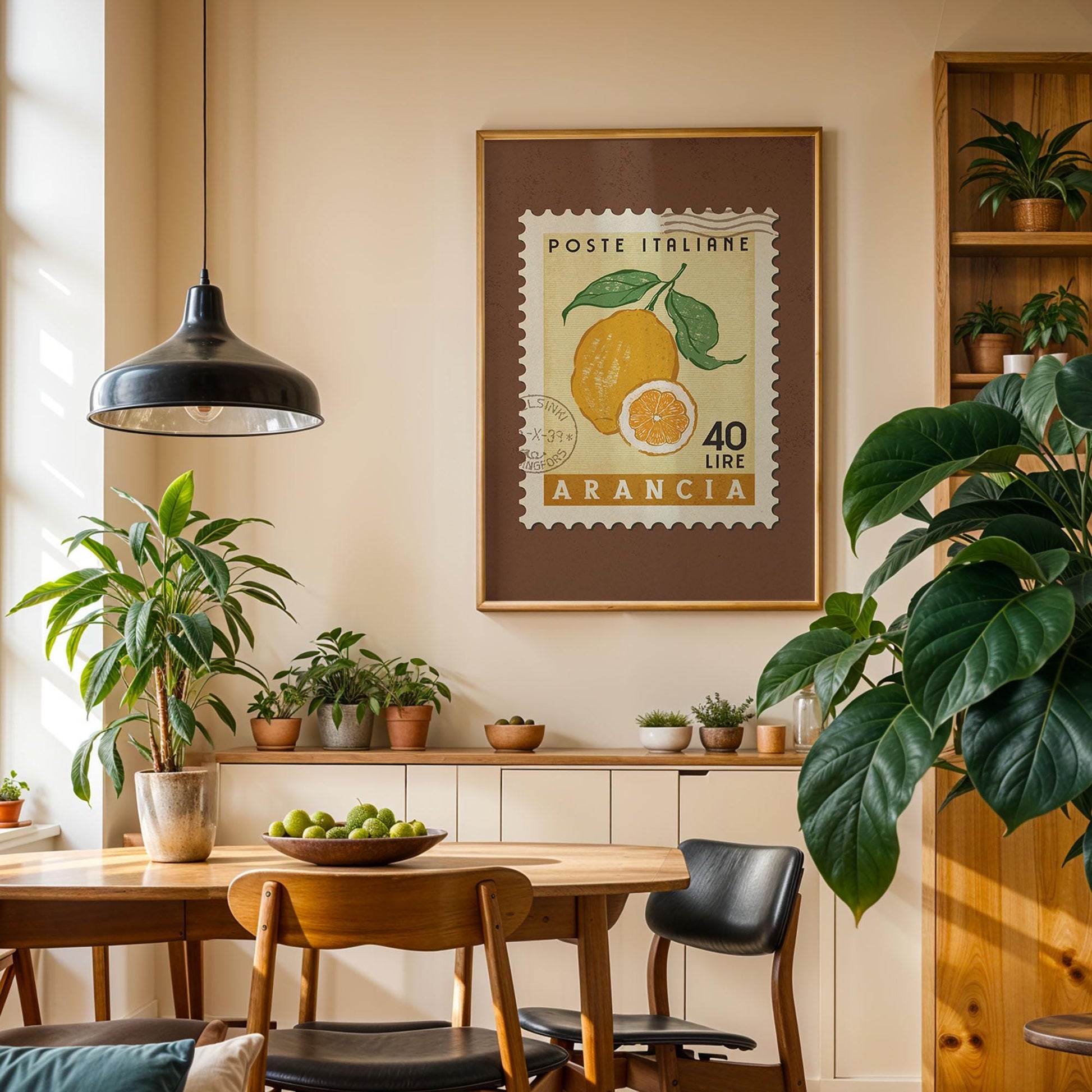 a cozy dining area with a wooden table, chairs, and a potted plant. A framed stamp with an orange and green illustration hangs on the wall above the table.