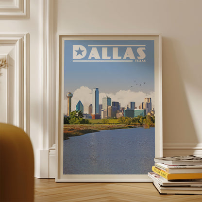 A framed poster of the Dallas skyline, with the city's iconic landmarks and skyline visible, is displayed on a wall.