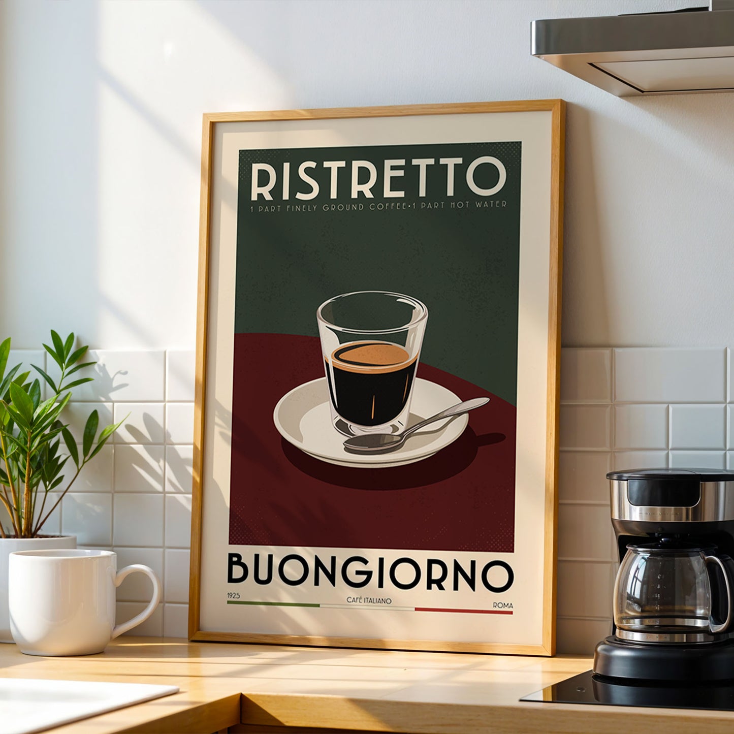 a framed poster of a cup of coffee with the text "RISTRETO" and "BUCKGIONO" printed on it, along with a small illustration of a cup and saucer. The poster is displayed on a kitchen counter, with a coffee maker and a potted plant visible in the background.