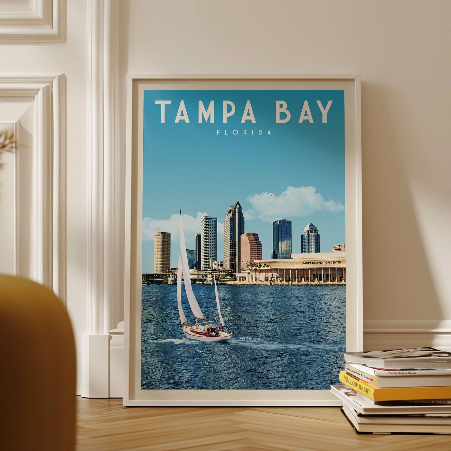 A framed poster of Tampa Bay, Florida, featuring a sailboat on the water with the city skyline in the background.